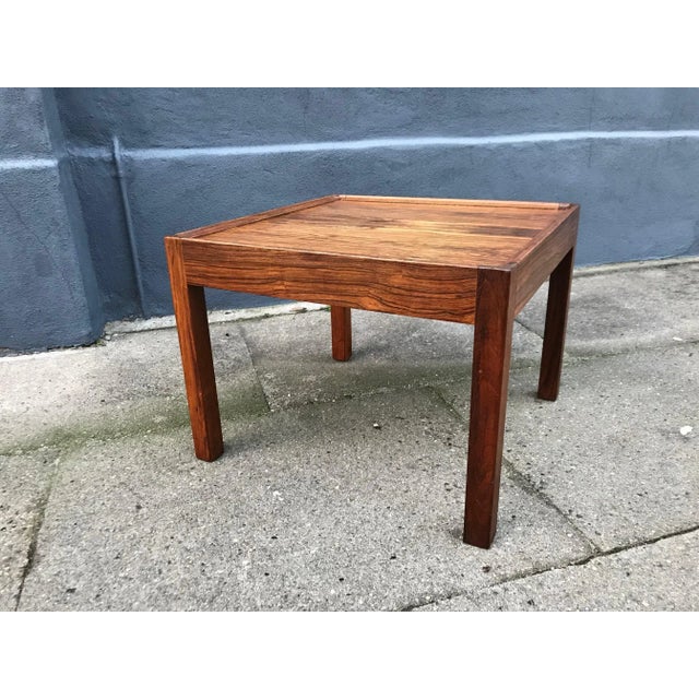 - A low square rosewood side table with a raised edge - It was manufactured in Denmark - In the style of Hans Wegner and...