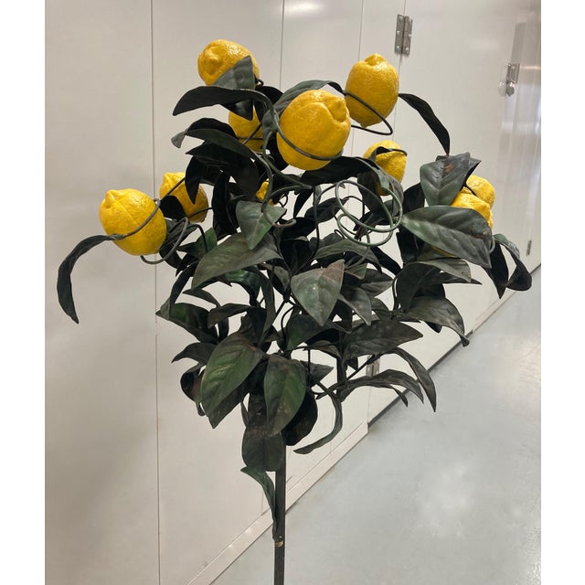 Painted tole lemon tree in shades of green adorned with removable yellow resin lemons. The tree is designed in two parts....