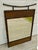 A distinctive vintage mirror featuring a faux‑bamboo wooden frame with woven rattan panels at the top and bottom, accented...