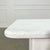 A pair of textured white pedestal side tables with rounded edges. Nice vintage condition, slight signs of wear to one...