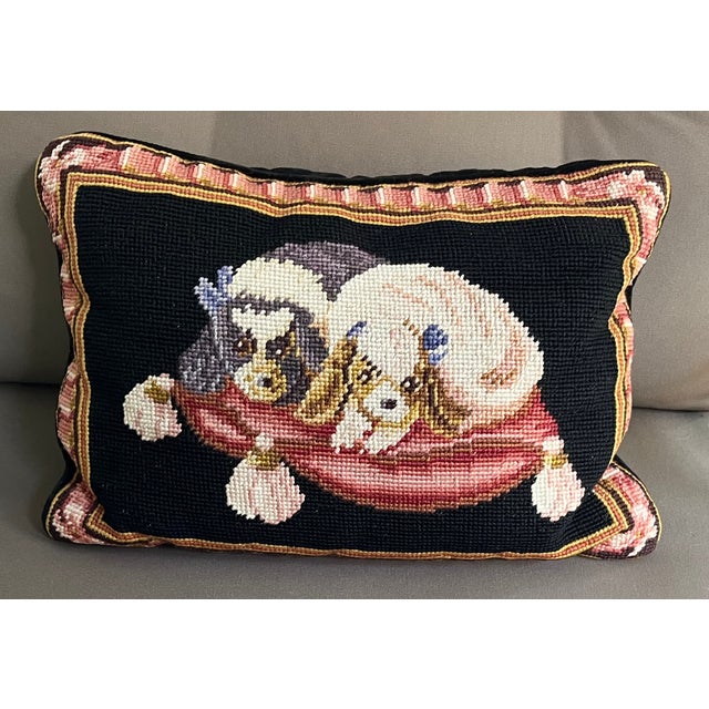 Needlepoint dog pillow of King Charles Spaniels. Mounted on black velvet back with self welt trim. Measures 13 3/4" across...