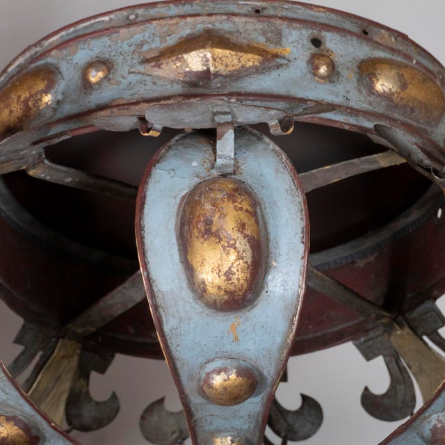 Distressed metal Spanish revival style pendant with gold paint accents.