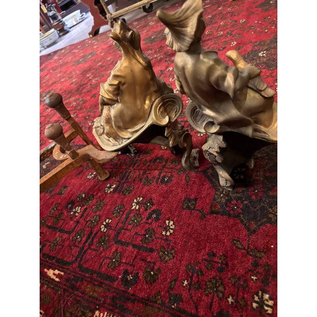 A striking and highly decorative pair of original early Louis XV gilt-bronze ormolu chenets, or fire dogs, dating to circa...