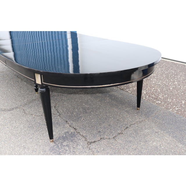 This signed Maison Jansen dining table is an exquisite example of mid-20th century Parisian design, blending refined...