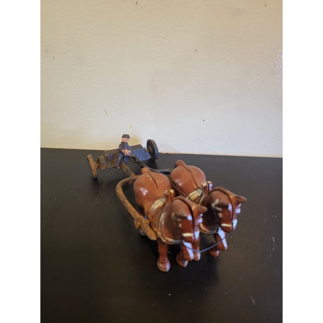 Crafted of cast iron, this toy horse, carriage and driver are made of cast iron. In very good structural condition...