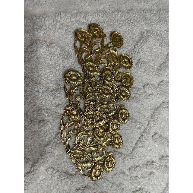 A striking vintage DIONNE gold floral metal wall art set, showcasing ornate openwork botanical designs in a classic...