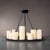 Hemel Chandelier from lighting designer Kevin Reilly. A round iron platform suspended by four-tapered rods. The platform...