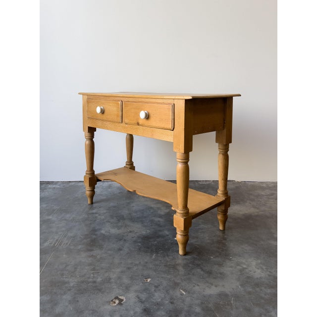 Crafted from warm, antique English pine, this 19th-century side table adds a charming touch to any empty corner. It...