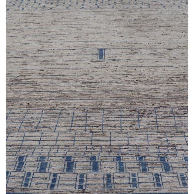 This modern casual tribal rug has been hand-knotted. The rug features a modern sub-geometric design, rendered in blue and...