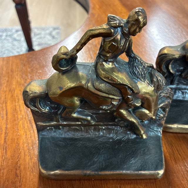 Heavy bookends. This set of bronze bookends features a cowboy and bucking bronco design created by Gladys Brown Edward’s...