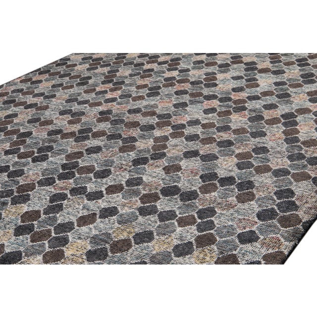Beautiful modern Soumak style Indian rug with a gray field. This rug has earthy tones in an all-over hexagonal design....