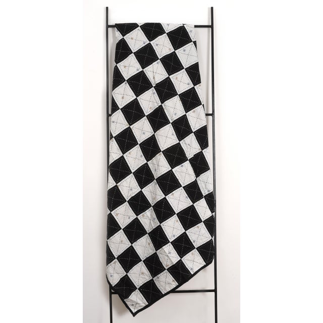 This beautifully handcrafted quilt, sized at 60 by 90 inches, was made using repurposed vintage linen in a patchwork of...