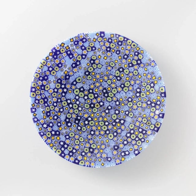 Murano glass plate made by melting together sections of glass rods in a furnace, with each section depicting a small...