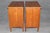 A handsome and beautifully matched pair of Kindel French Directoire-style cherry nightstands, combining the restrained...