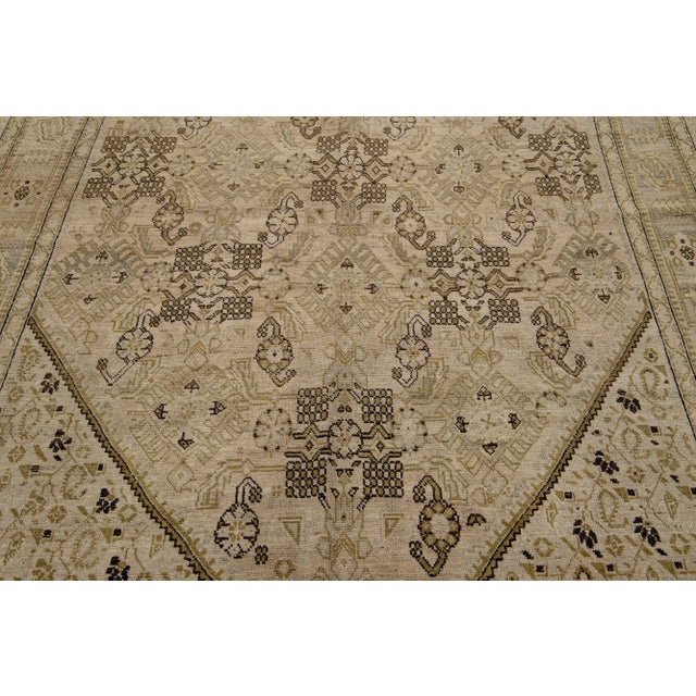 Add antique flair to your decor with this handmade Karabaugh wool area rug. It's the perfect accent piece, boasting a rich...