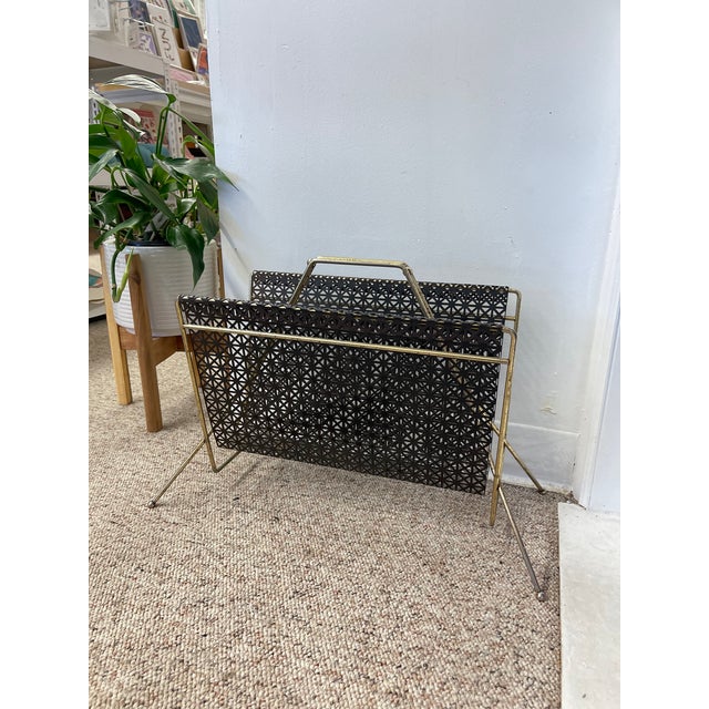 A sculptural and functional accent from the mid-20th century, this vintage magazine rack features a striking atomic-era...