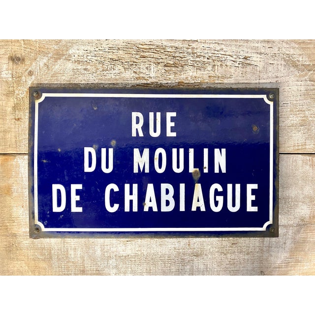 This original enamel on metal French street sign translates to Chabiage Mill Street. With the original hardware still...