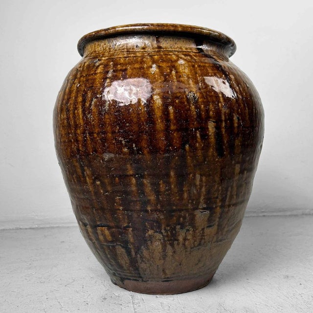 Decorative glazed earthenware tsubo, jar vase from Japan. The jar features a beautifully natural glaze in brown earth...