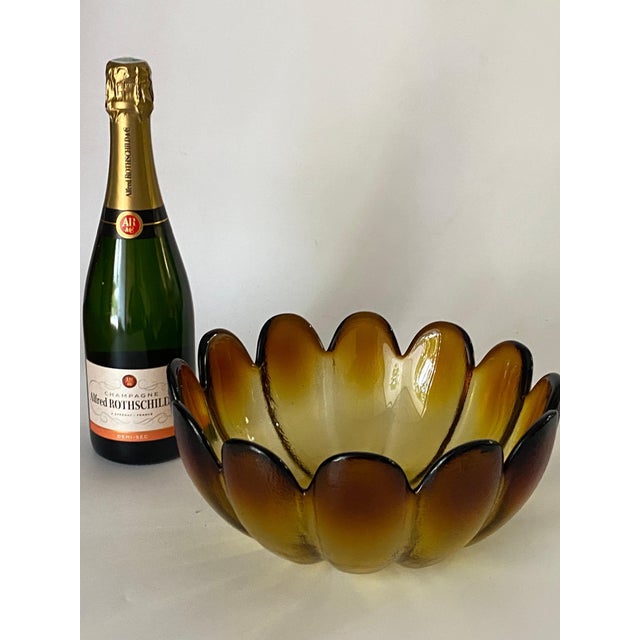 This bowl is in glass, brown and orange color, it is a salad bowl. It has been made in the 1970s, in France. Wear...