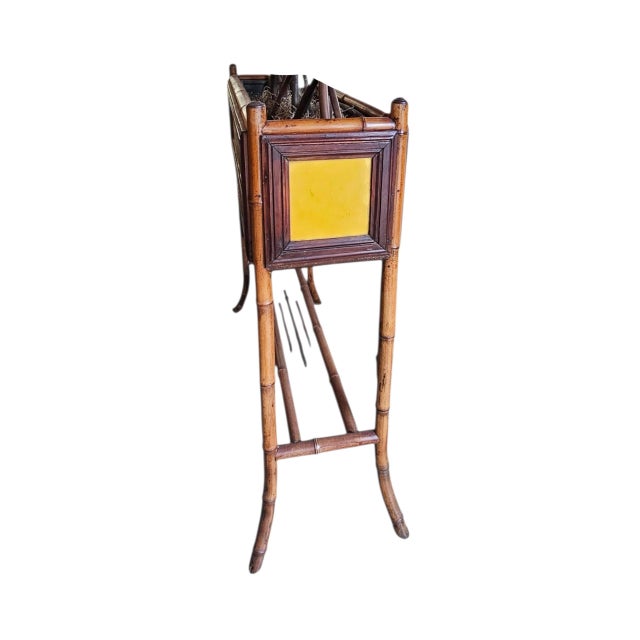 This charming stand features tortoiseshell bamboo frame with hi glaze tiles on all sides and metal tray/insert.