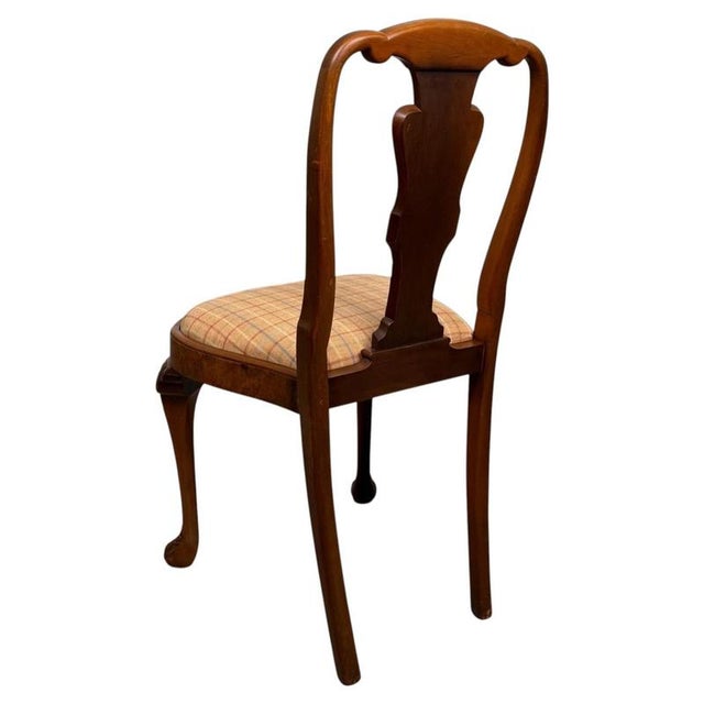 An impressive and beautifully crafted set of eight 20th-century dining chairs, constructed in richly figured burr walnut...