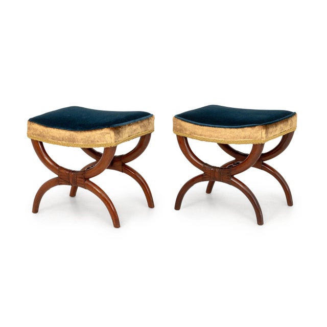 Pair of French Empire Style Blue Velvet and Golden Upholstered Curule Stools, with carved wood X-form bases. 19" H x...