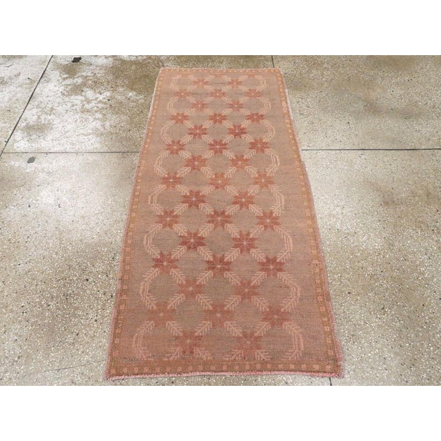 A vintage Turkish Anatolian throw rug. Brown stars and diagonal feathery leaves form the field pattern of this furry...