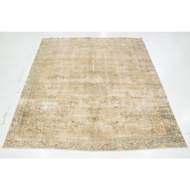 This vintage hand-knotted wool rug features a beige field with brown accents throughout the design. This rug measures...