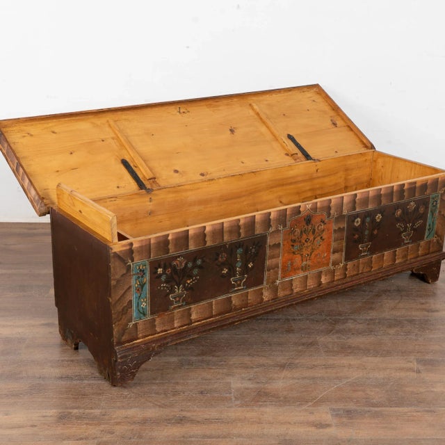 The painted finish is all original on this rustic pine flat top narrow trunk which may also serve as a bench. Flowers were...