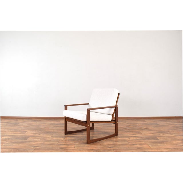 This armchair was made in Denmark in the 1960s. The armchair frame is made of solid teak and been professionally and...