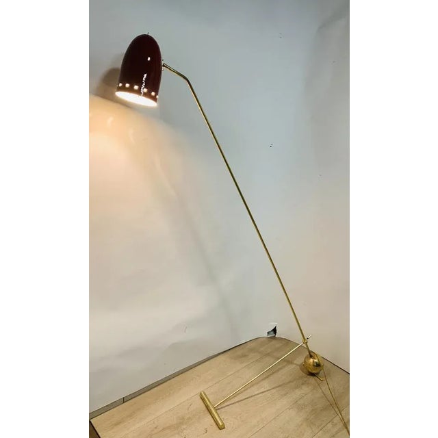 Floor lamp, used alongside the sofa, the central auction can lower up to the ground, scrolling on the base axis, the shade...