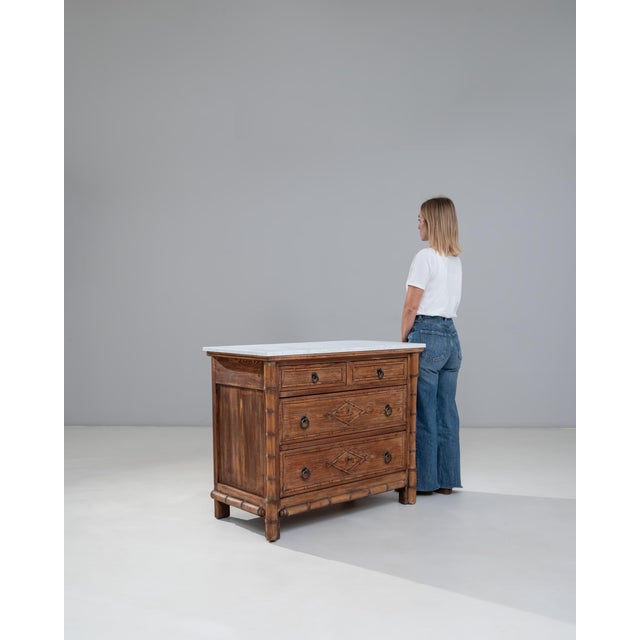 This 1900s French faux bamboo chest of drawers with a marble top showcases the charm and craftsmanship of late-19th- to...