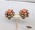 1960s goldtone curled "ribbon" edges with faux-coral bead center clip earrings. Marked "NAPIER PAT. PEND." Measure: 1 1/8...