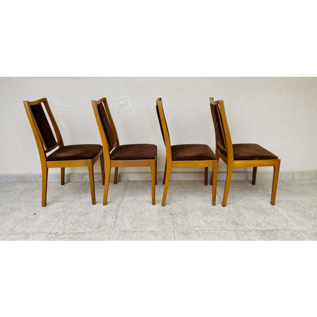Exquisite set of four dining chairs by Nathan Furniture, a British brand renowned for the quality of its solid wood...
