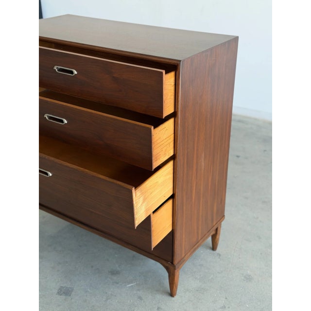 W44 D18 H27 Beautiful vintage walnut tallboy dresser featuring a clean mid century silhouette, sculpted tapered legs, and...