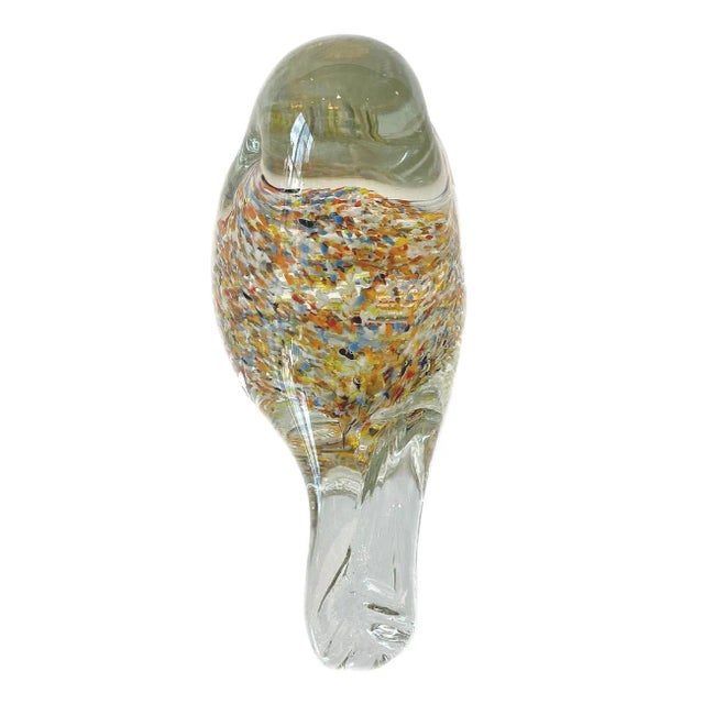 This paper weight/figurine is clear with multi colors. Measures H:4.5" W:5.5" D:3" Bottom has etched writing. Part of the...