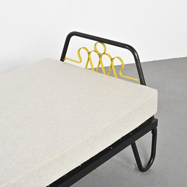Daybed with black lacquered metal tube legs typical of the work of the French designer Jacques Hitier, with headboard and...