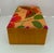 A vibrant vintage jewelry box covered in handwoven Thai silk, featuring a striking butterfly and floral textile in rich...