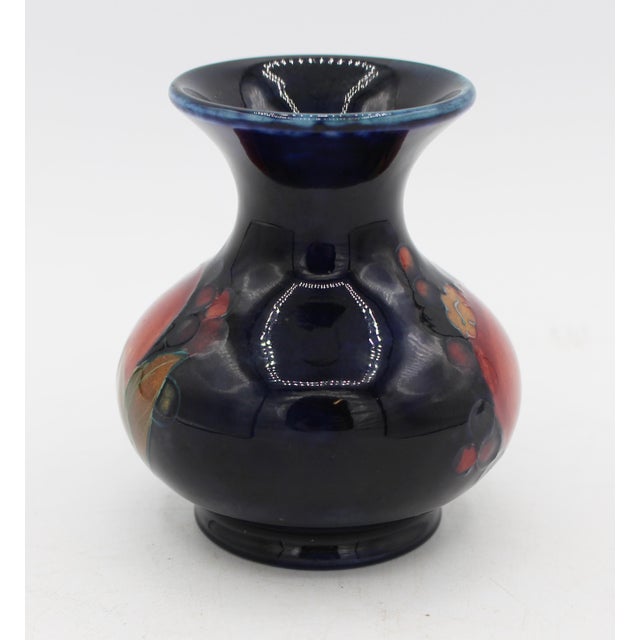 Small Moorcroft pomegranate pattern vase, 1928-1936, England. Signed "William Moorcroft"; stamps: "Potter to H.M. The...