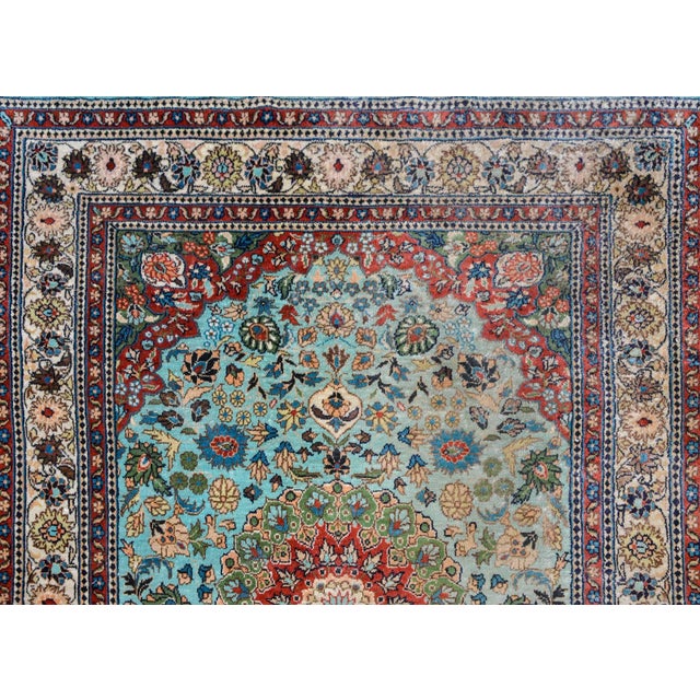 A beautiful vintage Chinese silk rug with a large central floral medallion amidst a field of large-scale flowers all woven...