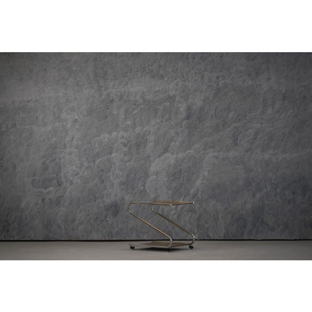 A vintage aluminium and plywood bar cart produced in Germany during the 1980's. This lightweight trolley combines...