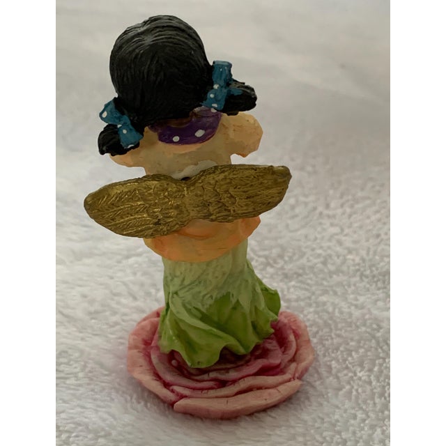 Ceramic jazz duo figurines. Man with hat and yellow jacket is playing brass trumpet. The young girl in a yellow and green...