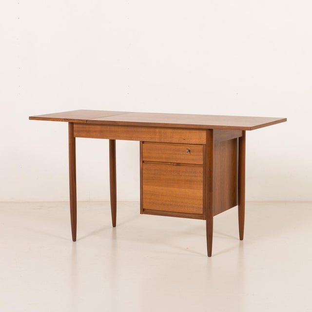 This scandinavian mid-century teak desk with extension from the 1960s, made in norway by austvoll møbelfabrikk, is a...