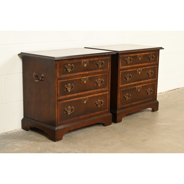 A beautiful pair of Georgian or Chippendale style three-drawer nightstands or bachelor chests In the manner of Baker...