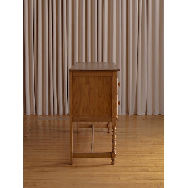 A beautifully crafted vintage oak chest featuring hand-carved detailing and classic proportions. This piece balances...