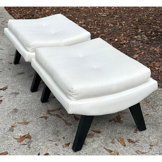 Good looking pair of soft faux leather ottomans. I love the scoop shape and splayed legs. Very clean with barely any signs...