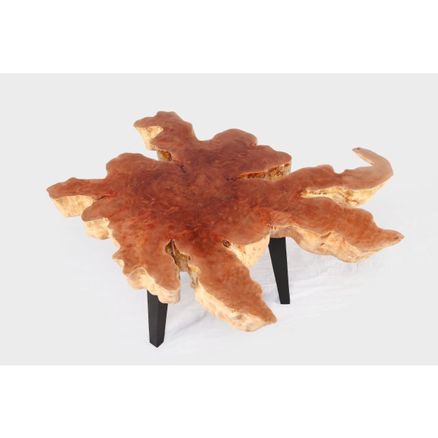 Hand constructed from lychee wood, the top of this coffee table is hand sanded and polished to show its natural lines and...