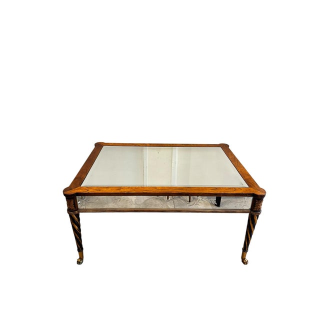 Bring timeless character to your home with this vintage mirrored coffee table. Featuring a rich wood frame, beveled glass...