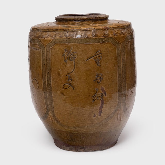 A beautiful example of Chinese folk pottery, this terracotta jar is a 19th-century pickling pot once used for fermenting...