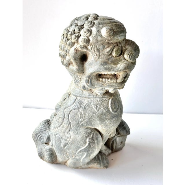 A wonderfully weathered vintage concrete foo dog, or Chinese guardian lion, with expressive sculptural detailing and a...